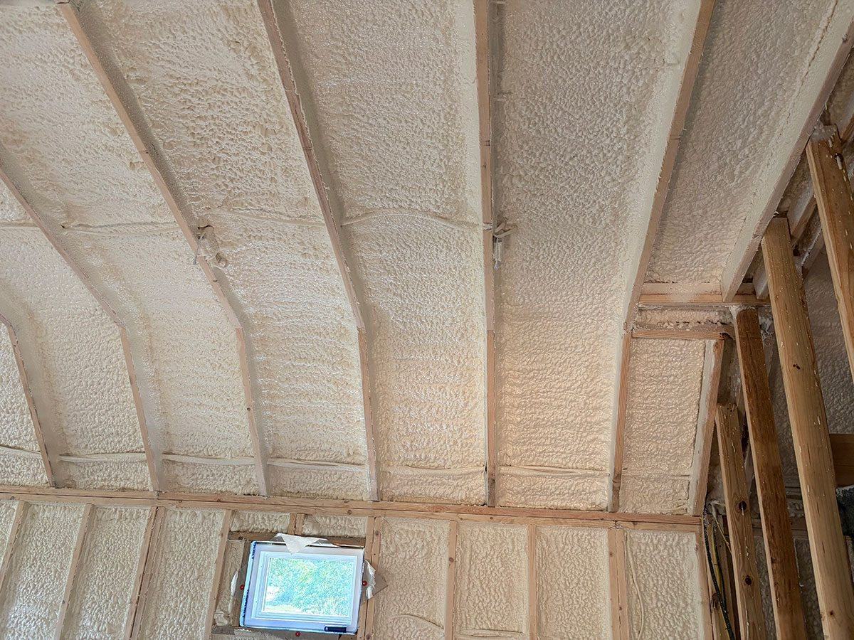 Spray foam insulation sealing a vaulted roofline